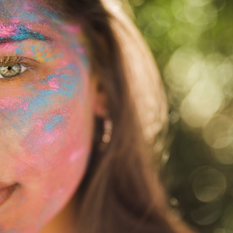 young-woman-with-pink-blue-holi-color-her-face